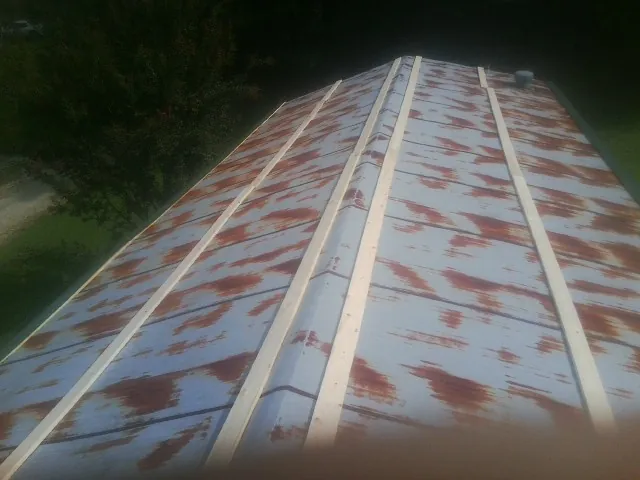 Rusted metal roof panels with new wood purlins before replacement — Storm Damage Roof Repair in Rawlings by Roofing Brothers